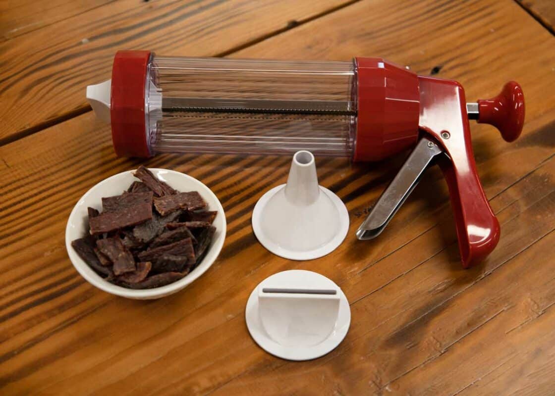 NESCO Jerky Gun On Table With Jerky